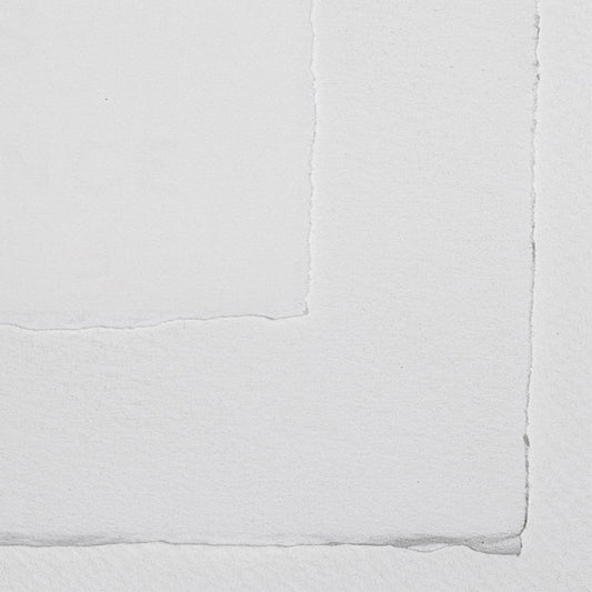 Sheets of Arches watercolour paper with deckled edges and a watermark stamp in the corner.