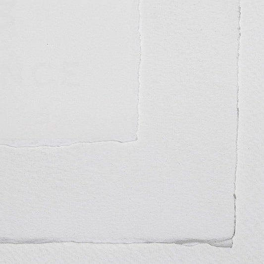 Sheets of Arches watercolour paper with deckled edges and a watermark stamp in the corner.