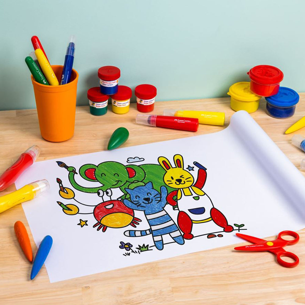 A partly unrolled Faber-Castell easy peel stickable colouring roll on the surface of a table coloured using crayons.