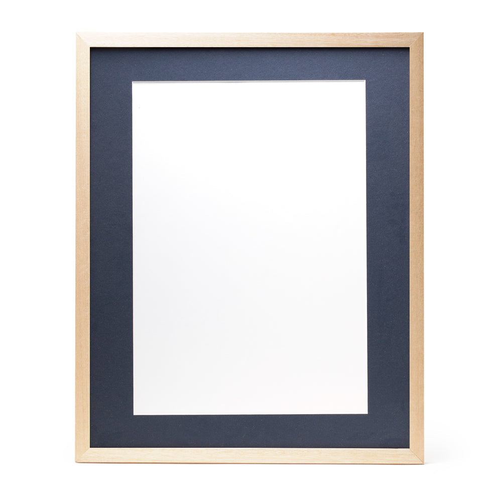A wooden frame with natural stain finish and a dark blue pre-cut framing matt.