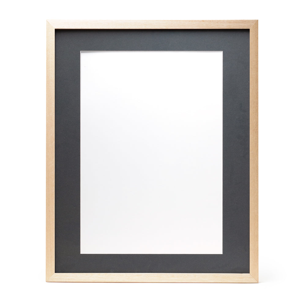 A wooden frame with natural stain finish and a dark grey pre-cut framing matt.