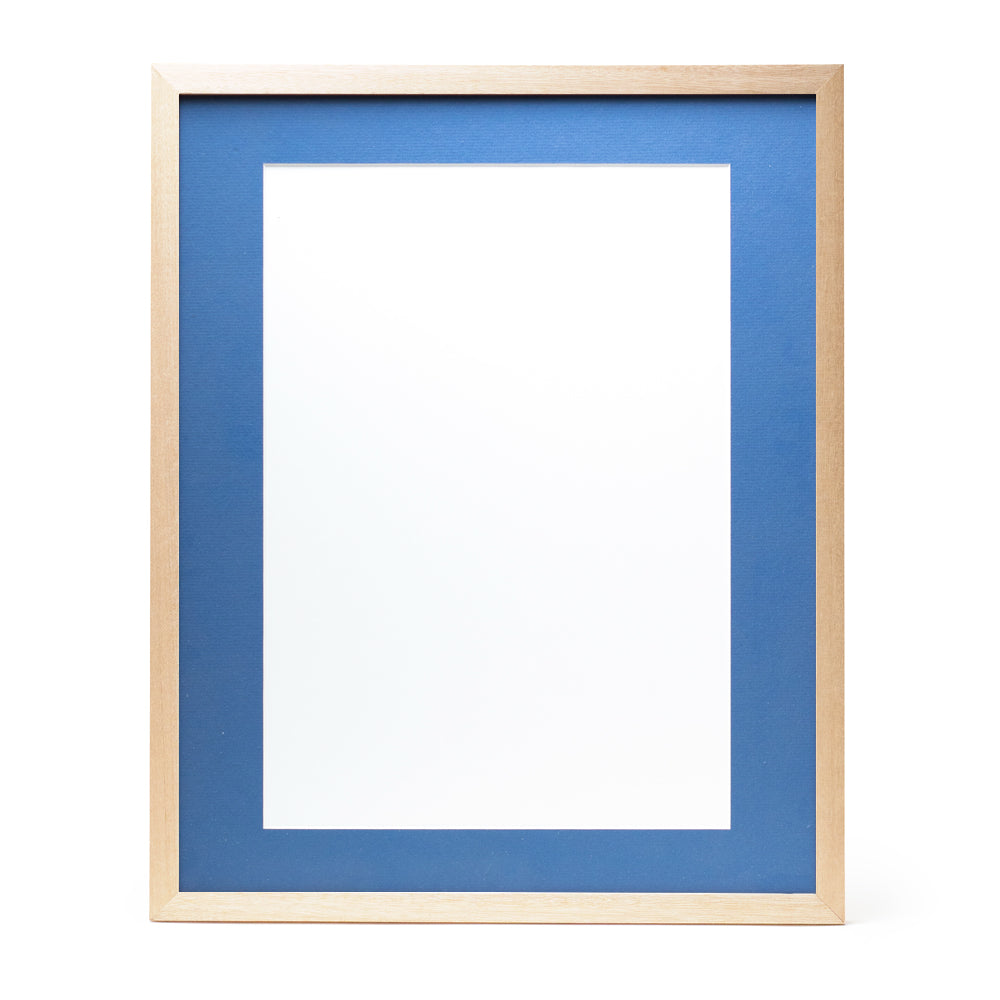 A wooden frame with natural stain finish and a mid-blue pre-cut framing matt.