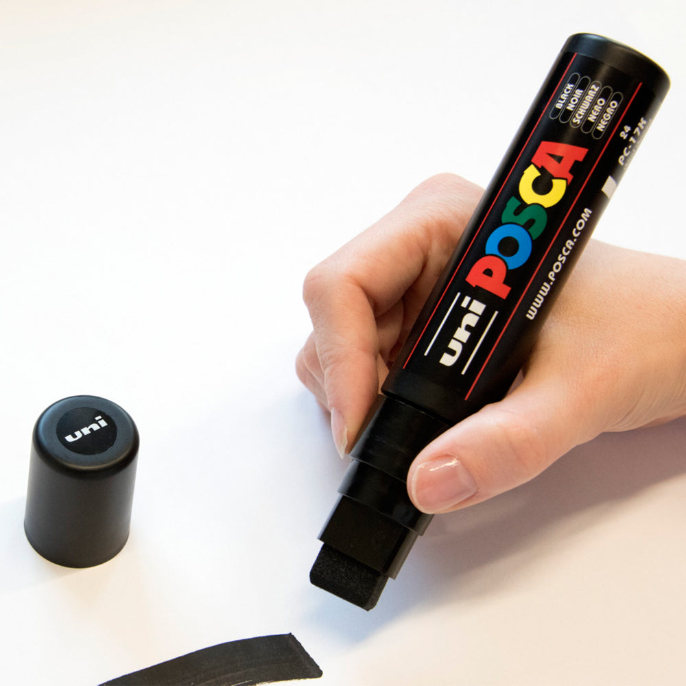 A thick line drawn with the black Uni Posca PC-17K extra bold chisel tip marker.