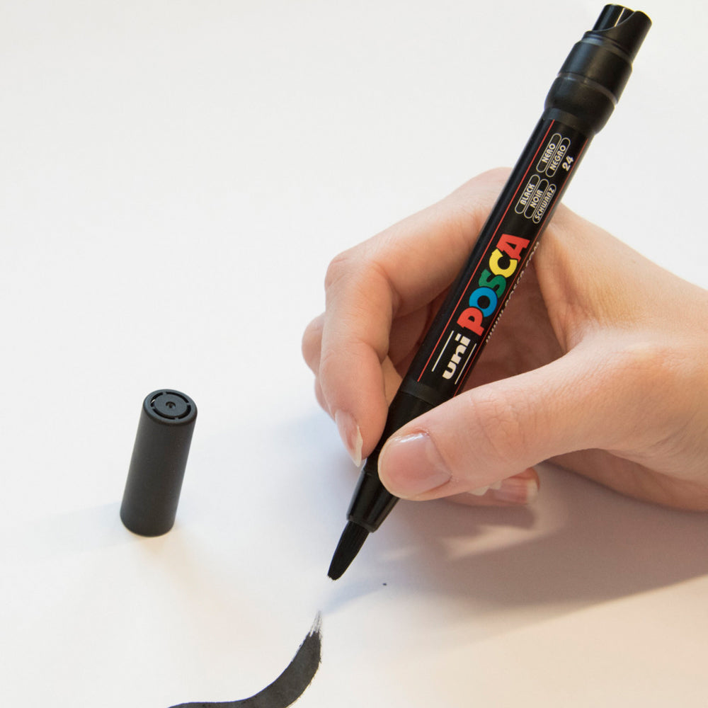 A brushed line drawn with the black Uni Posca PCF-350 flexible brush tip marker.