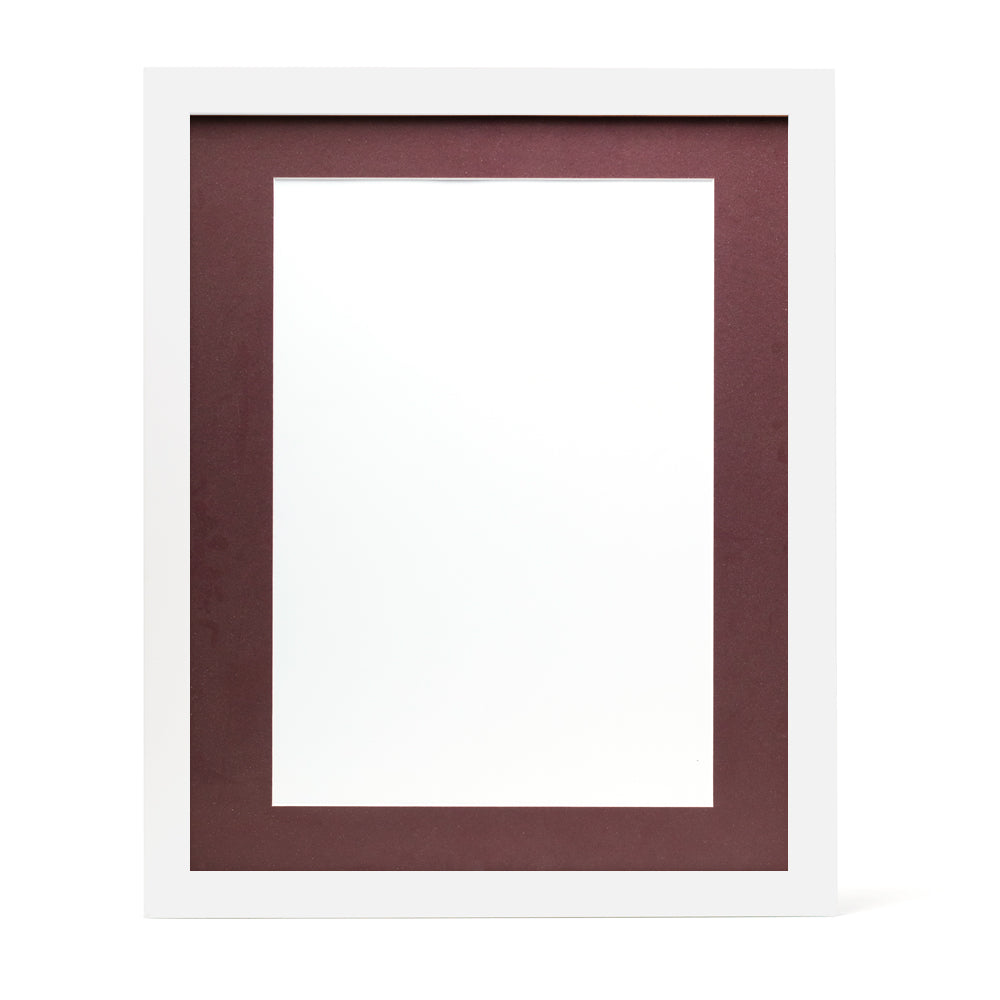 A white wooden frame with a burgundy red pre-cut framing matt.
