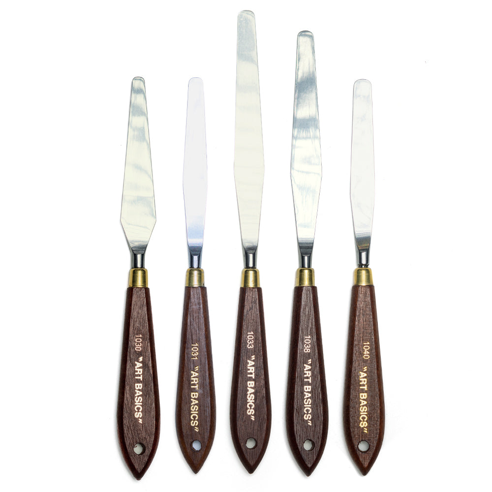 A range of Art Basics palette knives with metal blades attached to wooden handles with brass ferrules.