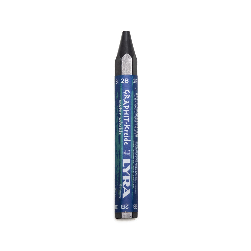 A 2B Lyra water soluble graphite stick. The stick is sharpened to a point and hexagonal in shape with a paper wrapper around the main body. 