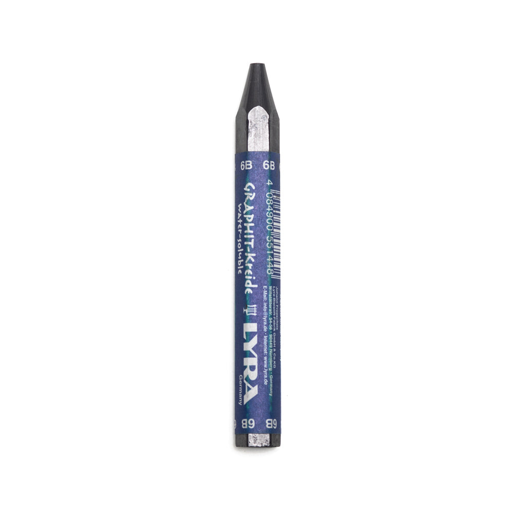 A 6B Lyra water soluble graphite stick. The stick is sharpened to a point and hexagonal in shape with a paper wrapper around the main body. 